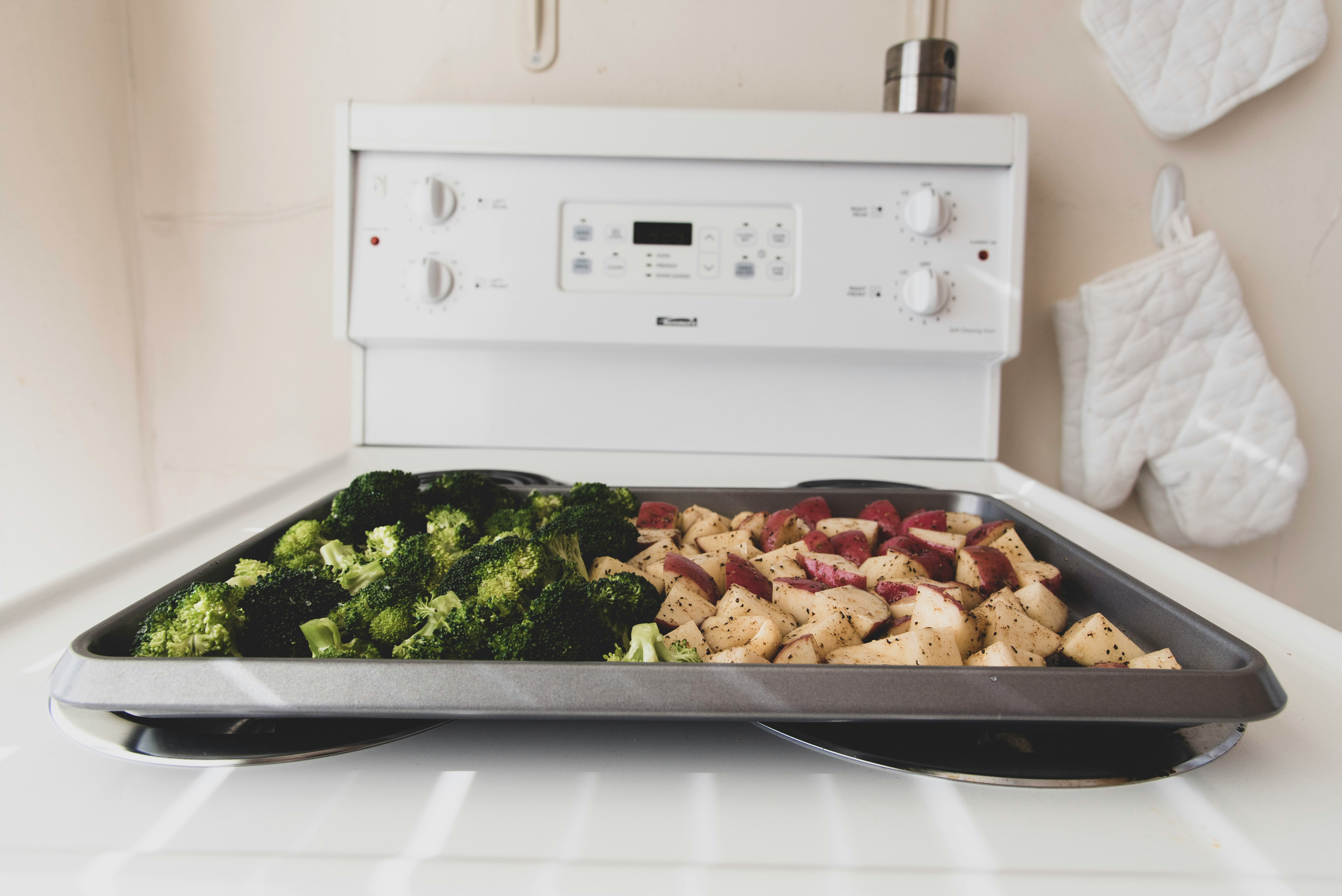 sliced broccoli on gray tray